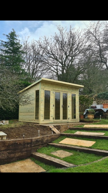 This is a picture of a Charlotte Pent Summerhouse in a customers garden