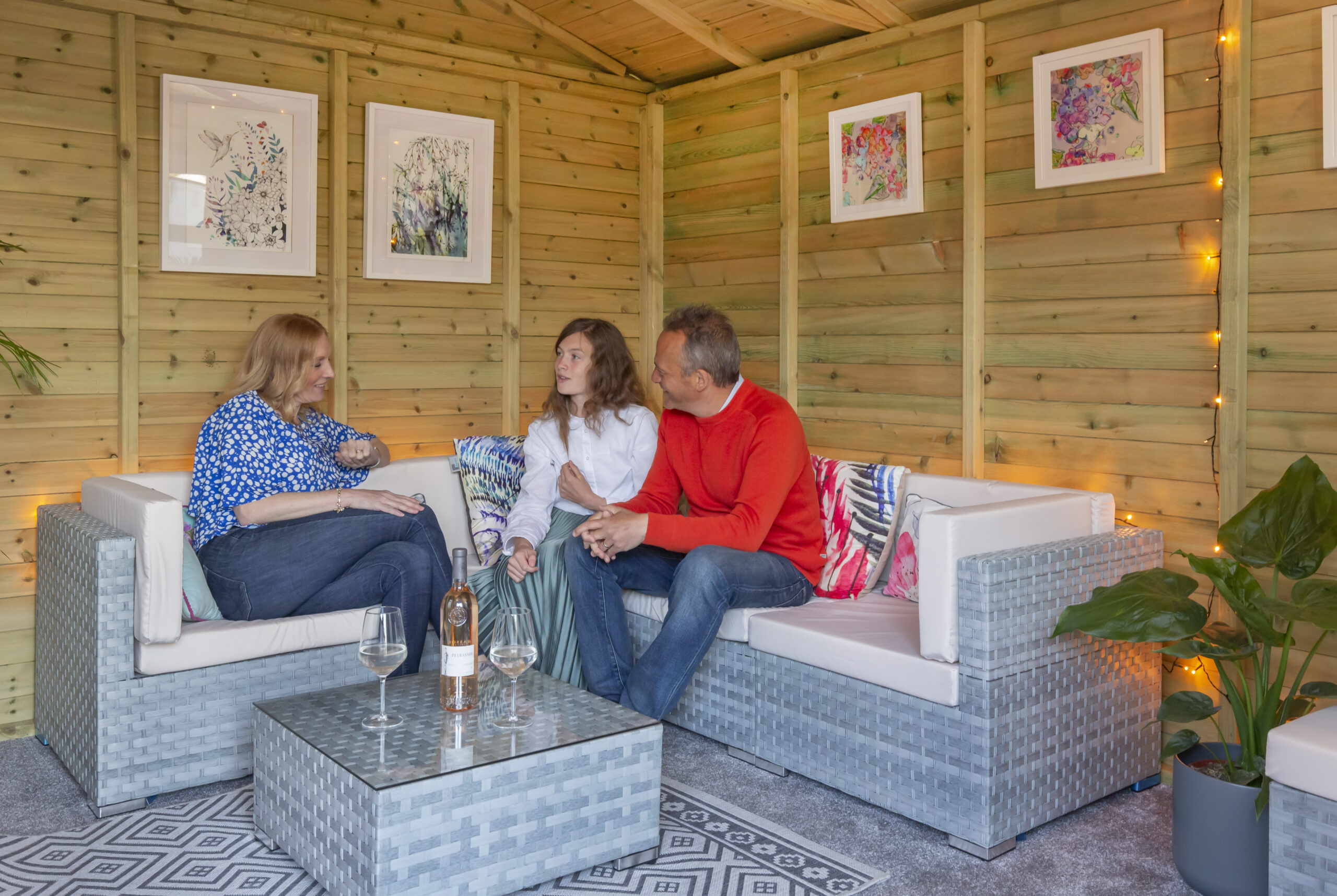 Family sitting in cosy summerhouse