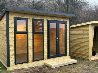 this image shows a pent summerhouse with upvc doors and windows